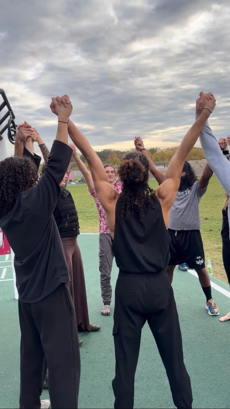 Participants moving barefoot together in the studio